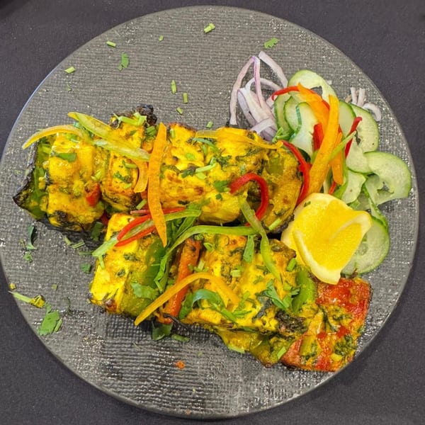 Urban Tandoor's vibrant Indian paneer tikka with bell peppers, onions, and a lemon wedge.